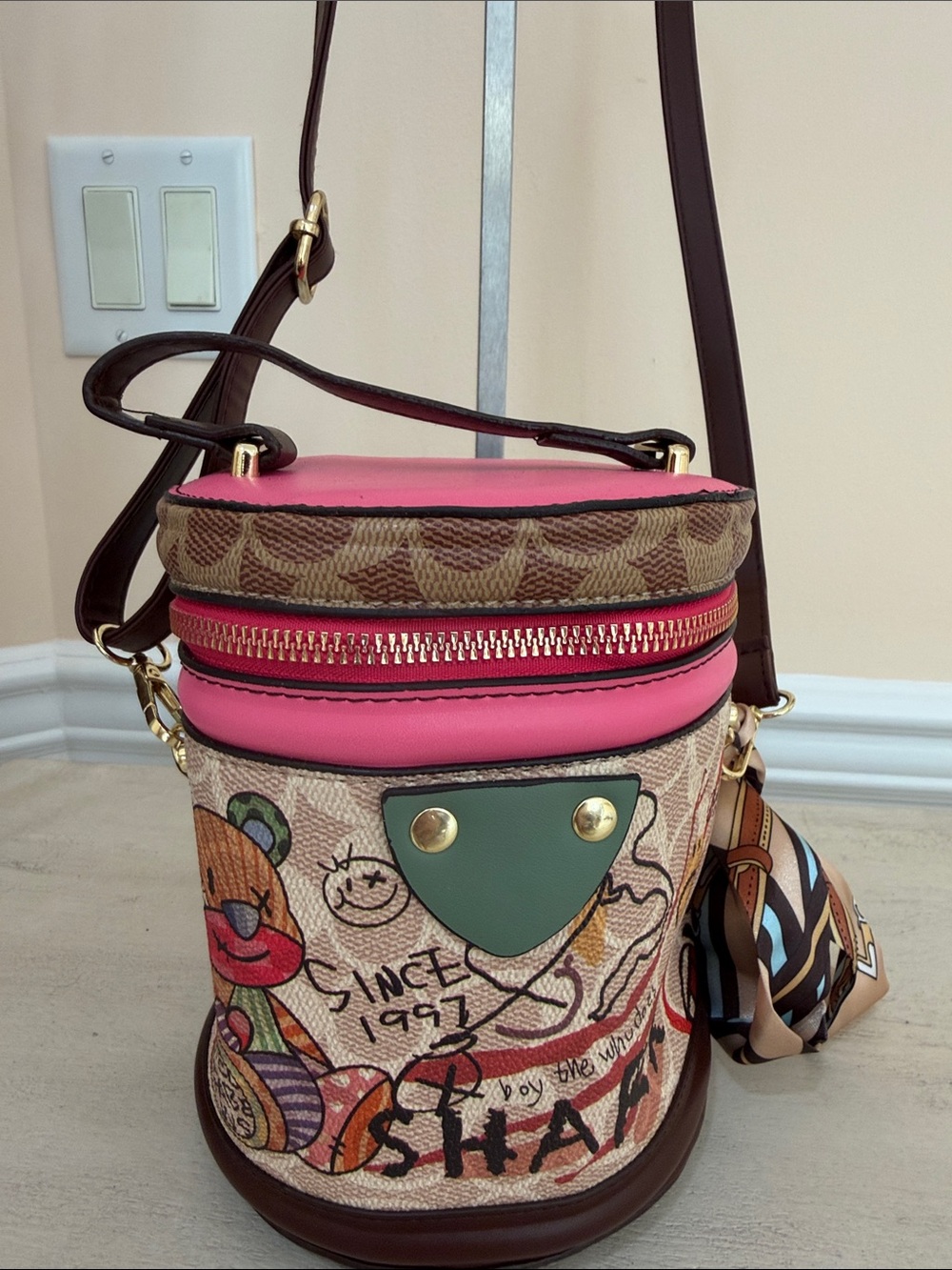 Pink Graffiti Print Bucket Crossbody Bag with Dark Brown Strap